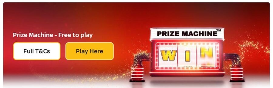 Promotional banner for the "Prize Machine" at a UK online casino, featuring the headline "Prize Machine - Free to play." The graphic displays a glowing red slot machine with "WIN" on the reels and sparkling gold dust effects. This targets search intent for "free to play casino games," "daily win slots," and "no deposit prize draws" in the UK market.