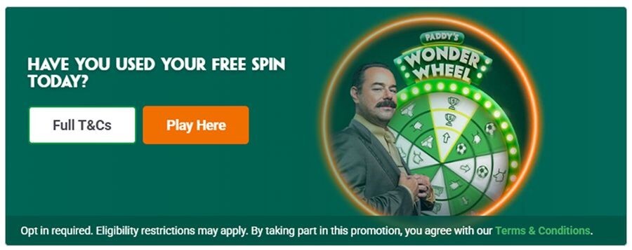 Promotional graphic for the Paddy's Wonder Wheel daily free spin game. Features the brand's mascot, a prize wheel, and clear buttons for "Play Here" and "Full T&Cs." Includes mandatory UKGC compliance text regarding opt-in requirements and eligibility.