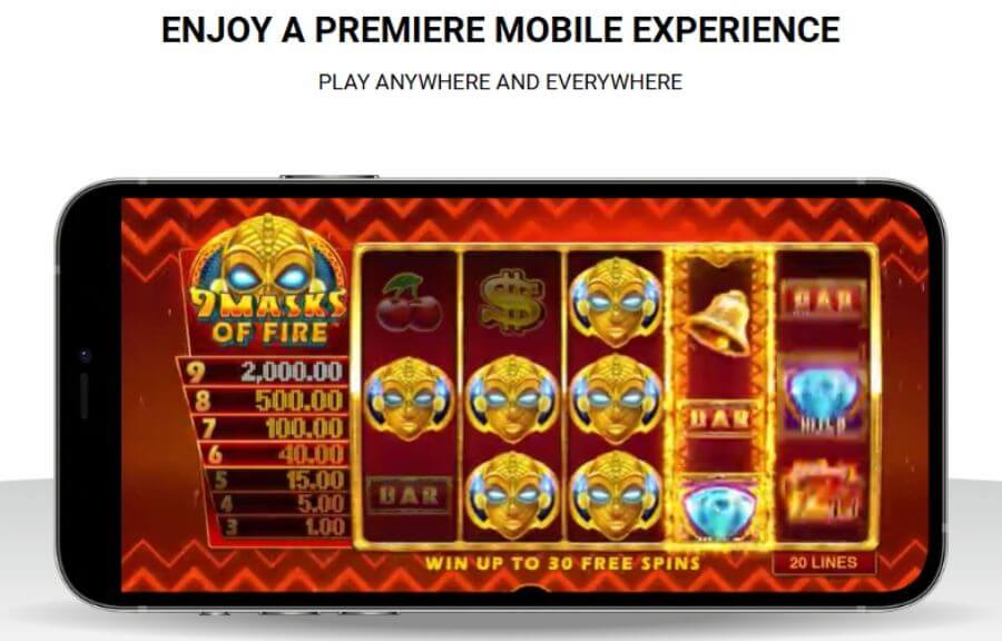 Promotional graphic reading "Enjoy a Premiere Mobile Experience - Play Anywhere and Everywhere" featuring a smartphone in landscape mode. The screen displays active real money gameplay of the 9 Masks of Fire online slot machine, showing its iconic golden scatter masks, prize ladder tiers, and a "Win up to 30 Free Spins" notice. This targets high-intent UK terms for "Zodiac Casino mobile app download," "play 9 Masks of Fire on phone," and "best mobile casino sites UK."