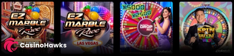 Horizontal live casino lobby row featuring four live game show cards set on a dark background. Left to right cards showcase: EZ Marble Race Bollywood with colourful marble tracks; EZ Marble Race Las Vegas featuring a illuminated strip background; Playtech's The Money Drop Live showcasing a female presenter in a purple dress next to a wheel displaying X5000 and X2500 multiplier callouts; and Playtech's Spin A Win Wild featuring a male presenter in a tuxedo jacket with a microphone.